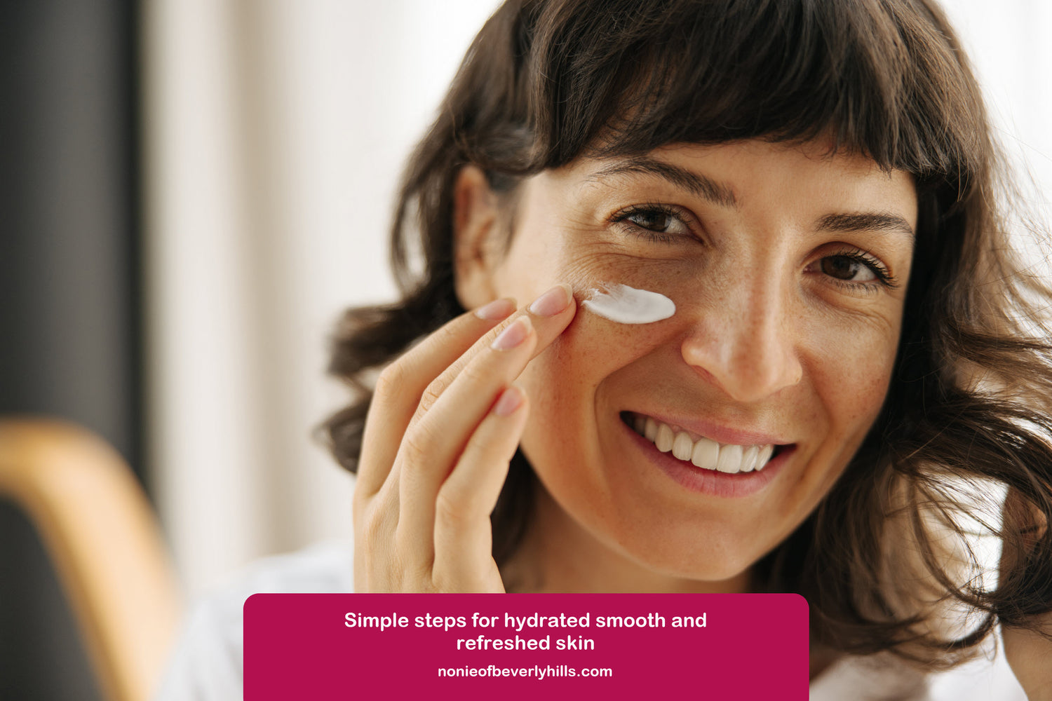 Woman applying skincare products as part of a daily AHA routine for dry skin.
