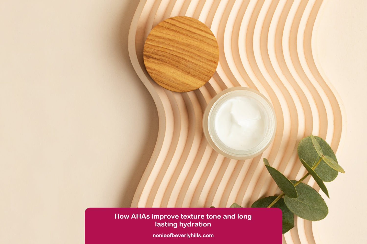 Close up of AHA cream in a round container with a wooden lid on a decorative beige background, featuring text about AHAs.