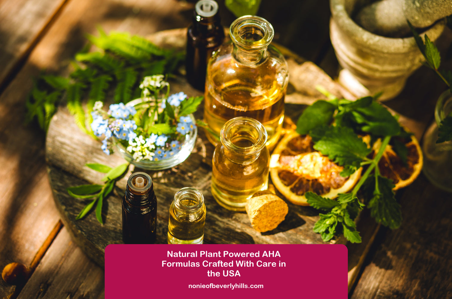 Glass bottles of botanical oils surrounded by dried citrus slices and fresh herbs on a wooden surface representing natural plant based AHA skincare ingredients.